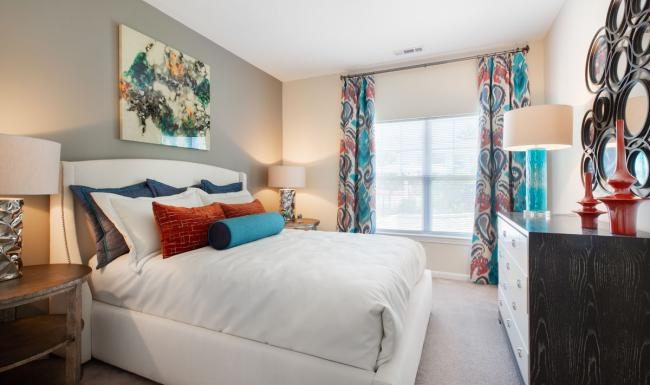 a bedroom with a bed and lamps